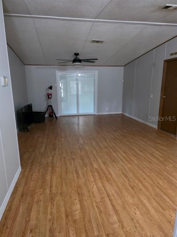 24427 Wild Turkey Road Paisley, FL 32767 - Photo 10 of 55 a view of an empty room with wooden floor