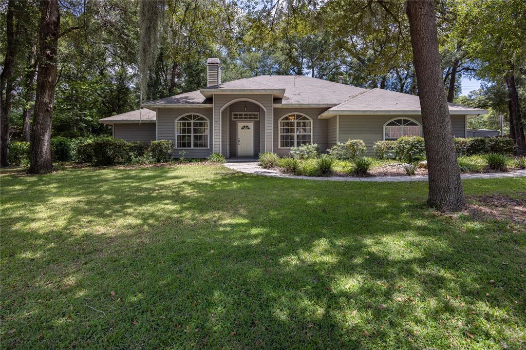 2103 Southwest 75th Terrace Gainesville, FL 32607 - Photo 1 of 1 a front view of a house with a garden