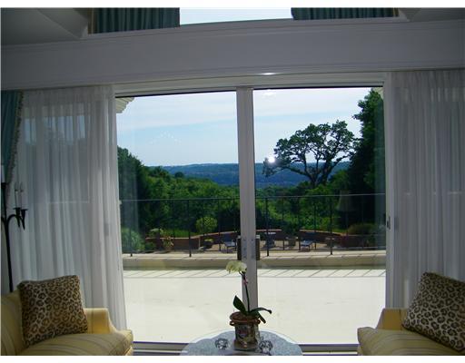 209 Spanish Tract Road Edgeworth, PA 15143 - Photo 10 of 18 Living Room. Upon enterting the Living Room, one s eye is drawn to the panoramic vistas offered. Sliding doors allow the entertaining space to expand to the beautiful balcony overlooking the pool and fountain.
