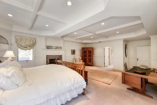 a spacious bedroom with a large bed and a dresser