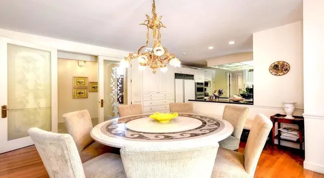 a view of a dining room with furniture and a chandelier