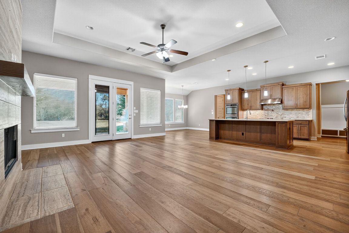112 Sweetleaf Cove Georgetown, TX 78633 - Photo 12 of 28 an empty room with wooden floor and windows