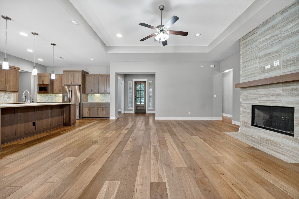 112 Sweetleaf Cove Georgetown, TX 78633 - Photo 13 of 28 a view of a kitchen with a sink and a fireplace