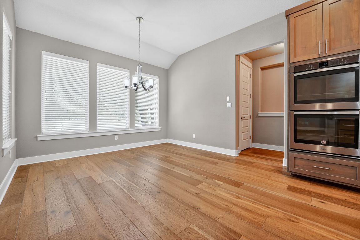 112 Sweetleaf Cove Georgetown, TX 78633 - Photo 16 of 28 a view of an empty room with a window and wooden floor
