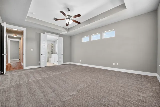 an empty room with fan and a ceiling fan