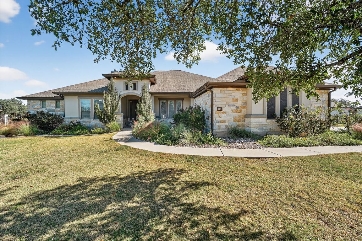 112 Sweetleaf Cove Georgetown, TX 78633 - Photo 2 of 28 a front view of a house with a yard and garage