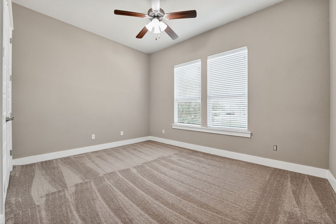 112 Sweetleaf Cove Georgetown, TX 78633 - Photo 8 of 28 an empty room with windows and fan