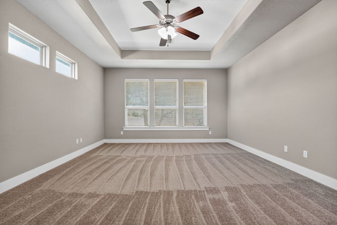 112 Sweetleaf Cove Georgetown, TX 78633 - Photo 9 of 28 a view of an empty room with wooden floor and a window