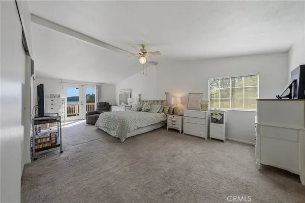 a spacious bathroom with a sink double vanity granite and a mirror