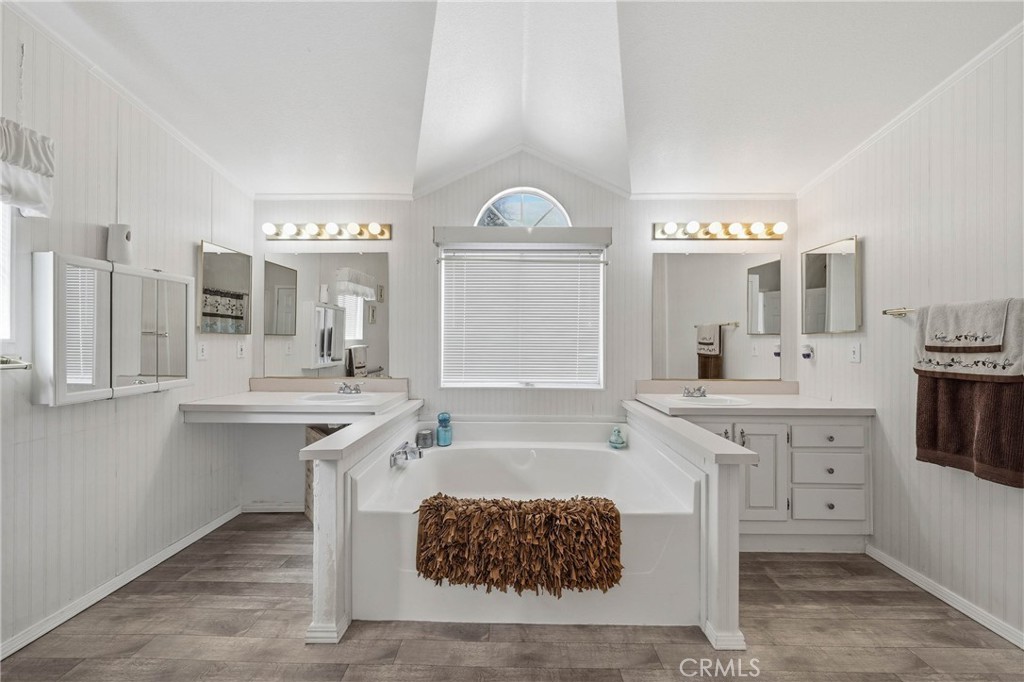 7765 Verna Way Lucerne, CA 95458 - Photo 13 of 37 a spacious bathroom with a sink double vanity granite and a mirror