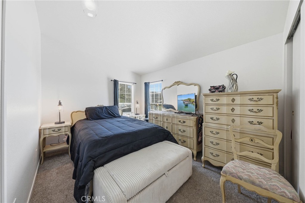 7765 Verna Way Lucerne, CA 95458 - Photo 15 of 37 a bedroom with a bed and a dresser