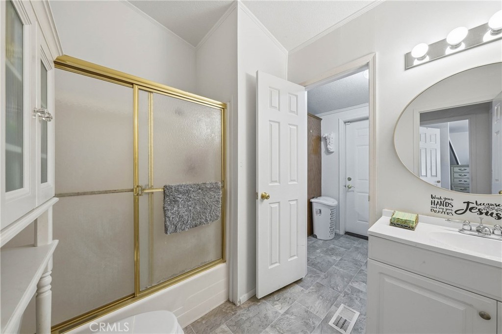 7765 Verna Way Lucerne, CA 95458 - Photo 17 of 37 a bathroom with a shower sink and mirror