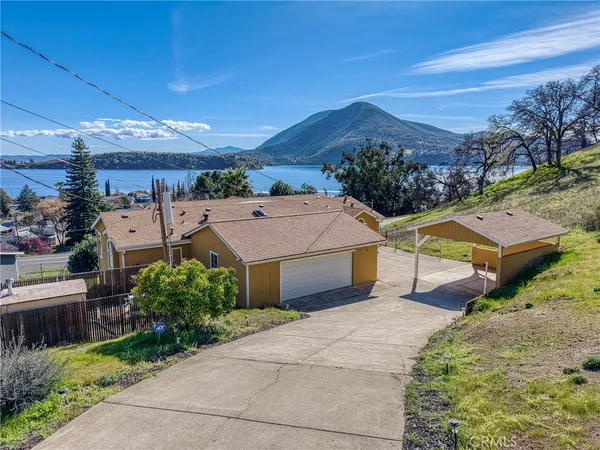 a view of a house with a deck and a yard