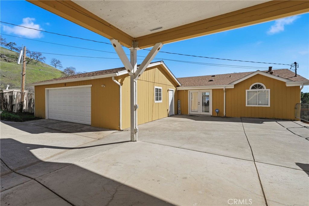 7765 Verna Way Lucerne, CA 95458 - Photo 23 of 37 a front view of a house with garage