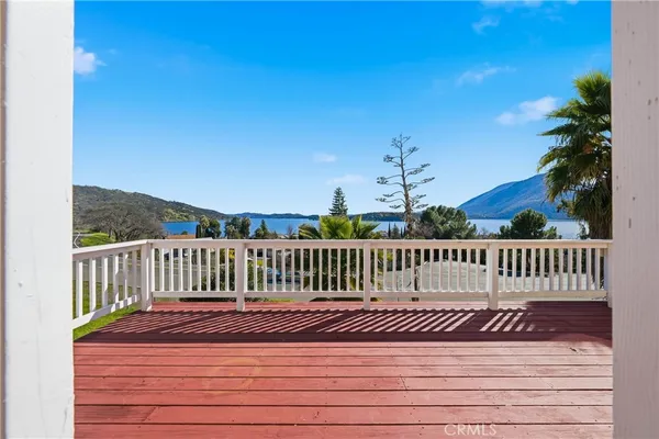 a view of balcony with wooden floor and fence