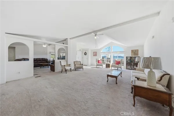 a living room with furniture a fireplace and a chandelier