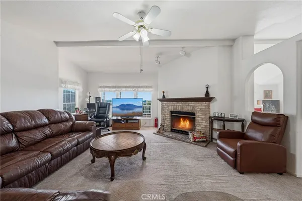 a kitchen with stainless steel appliances granite countertop a refrigerator a sink dishwasher a dining table and chairs with wooden floor