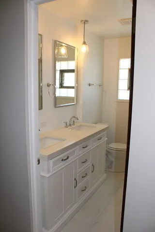 a bathroom with a granite countertop sink a mirror a and a