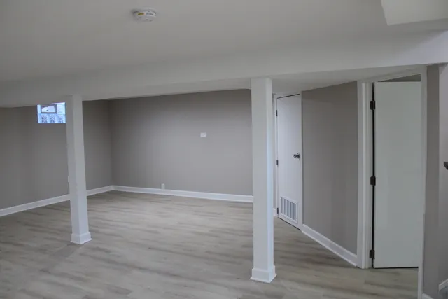 an empty room with wooden floor & closet