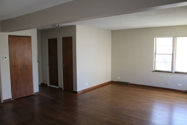 724 Barnsdale Road, Unit 2 La Grange Park, IL 60526 - Photo 5 of 20 an empty room with wooden floor and windows