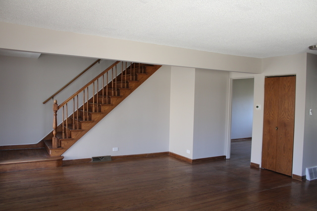 724 Barnsdale Road, Unit 2 La Grange Park, IL 60526 - Photo 6 of 20 a view of an empty room with wooden floor and stairs