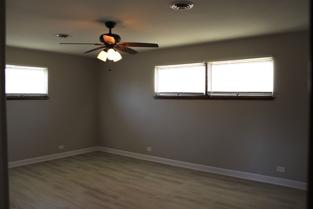 724 Barnsdale Road, Unit 2 La Grange Park, IL 60526 - Photo 7 of 20 an empty room with wooden floor and windows