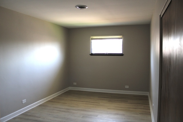 724 Barnsdale Road, Unit 2 La Grange Park, IL 60526 - Photo 10 of 20 an empty room with wooden floor and windows