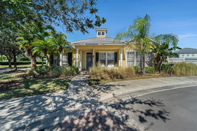 a view of a house with a tree in front
