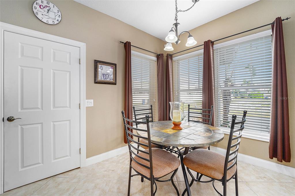 5516 Luminar Pointe Lane Apollo Beach, FL 33572 - Photo 11 of 34 a view of a dining room with furniture and window