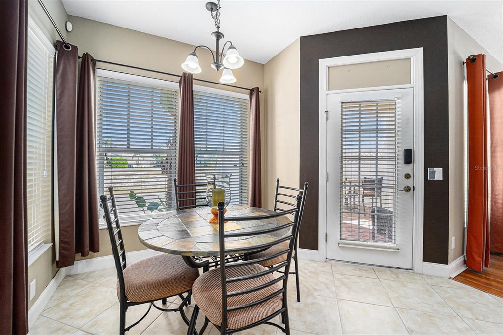 5516 Luminar Pointe Lane Apollo Beach, FL 33572 - Photo 12 of 34 a view of a dining room with furniture and window
