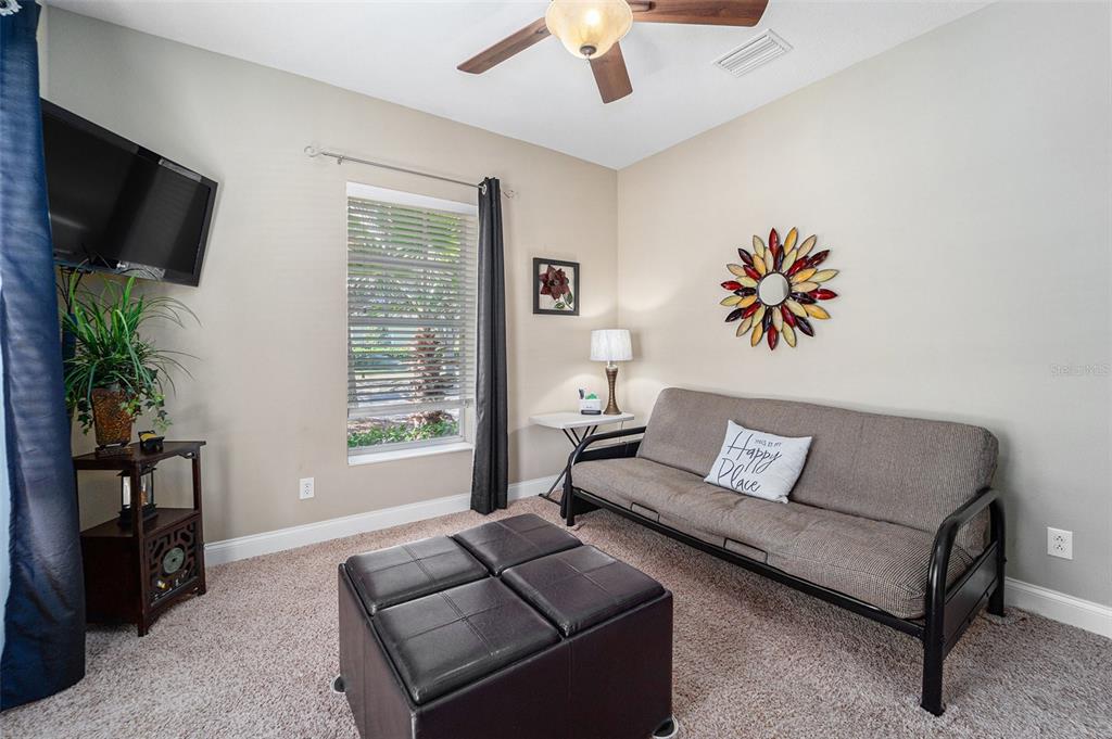 5516 Luminar Pointe Lane Apollo Beach, FL 33572 - Photo 19 of 34 a living room with furniture and a flat screen tv