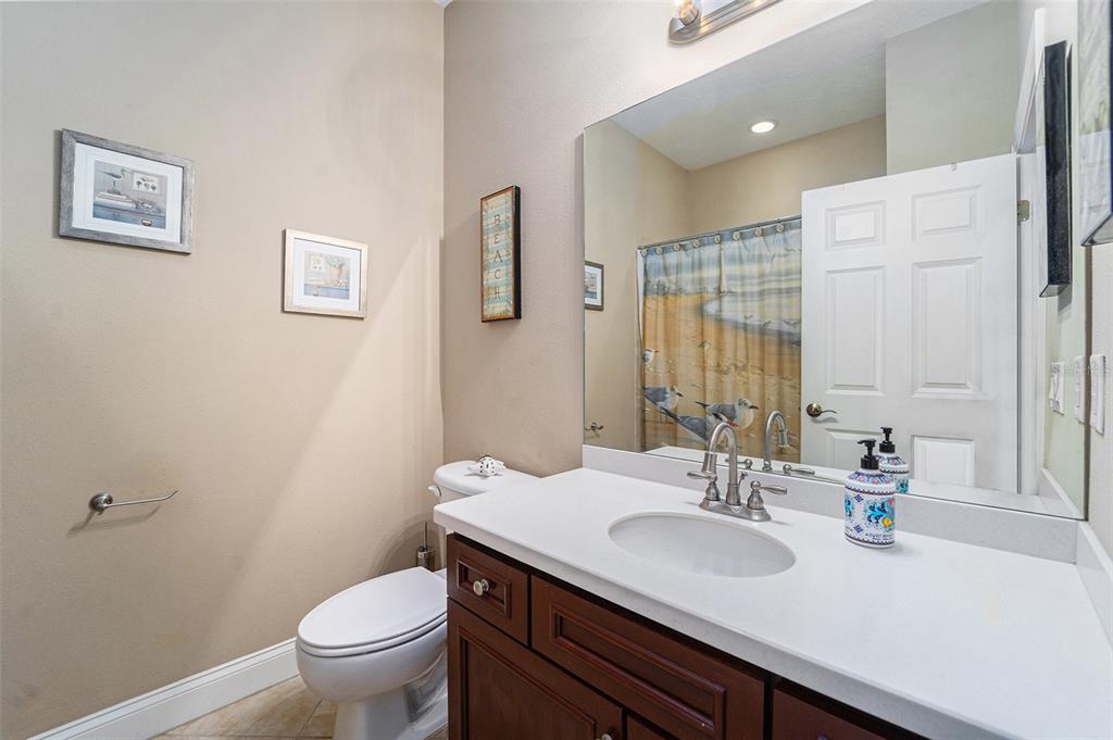 5516 Luminar Pointe Lane Apollo Beach, FL 33572 - Photo 20 of 34 a bathroom with a granite countertop sink toilet and a mirror