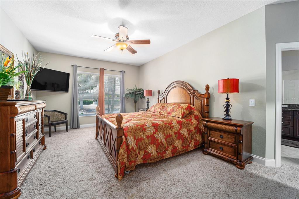 5516 Luminar Pointe Lane Apollo Beach, FL 33572 - Photo 22 of 34 a bedroom with a bed and a flat screen tv
