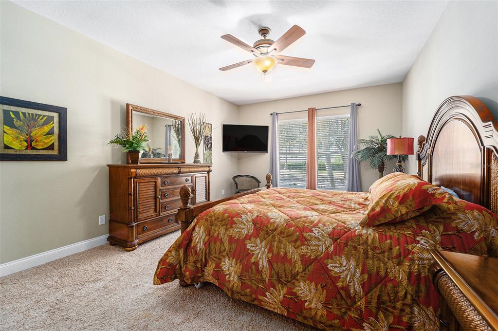 5516 Luminar Pointe Lane Apollo Beach, FL 33572 - Photo 24 of 34 a bedroom with a bed and a flat screen tv