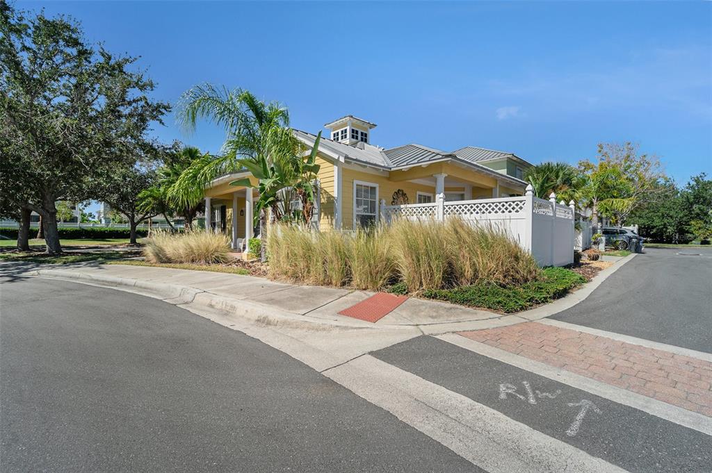 5516 Luminar Pointe Lane Apollo Beach, FL 33572 - Photo 29 of 34 a front view of a house with a yard and palm trees