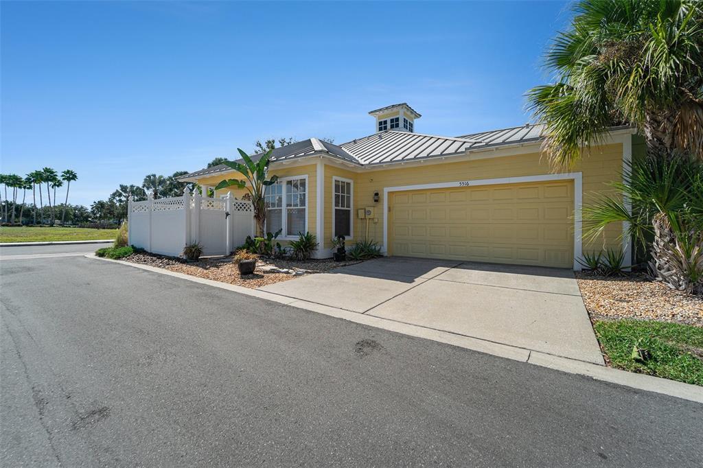 5516 Luminar Pointe Lane Apollo Beach, FL 33572 - Photo 31 of 34 a front view of a house with a yard and garage