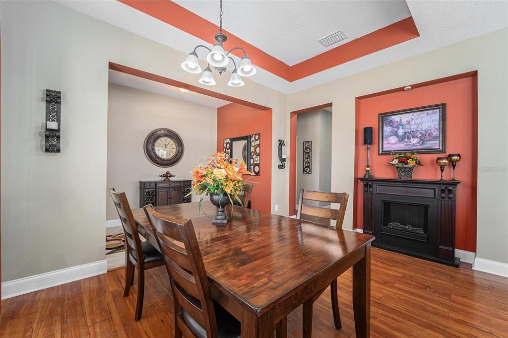 5516 Luminar Pointe Lane Apollo Beach, FL 33572 - Photo 7 of 34 a dining room with furniture and wooden floor