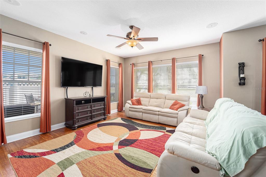 5516 Luminar Pointe Lane Apollo Beach, FL 33572 - Photo 9 of 34 a living room with furniture and a flat screen tv