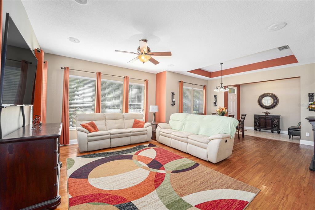 5516 Luminar Pointe Lane Apollo Beach, FL 33572 - Photo 10 of 34 a spacious bedroom with a bed a couch and dresser