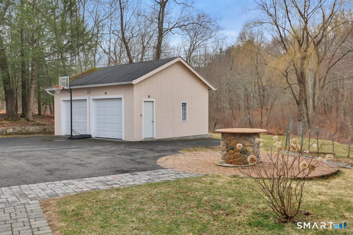 112 Weekeepeemee Road Bethlehem, CT 06751 - Photo 34 of 40 The garage does not have power, the current owner runs power from the shed out to the garage for the automatic garage door opener. There is a workbench and ample room for storage.