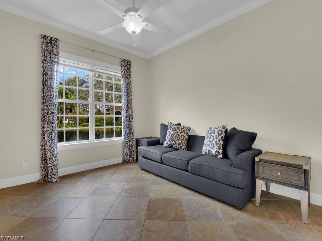 9983 Colonial Walk North Estero, FL 33928 - Photo 17 of 39 a living room with furniture and a large window