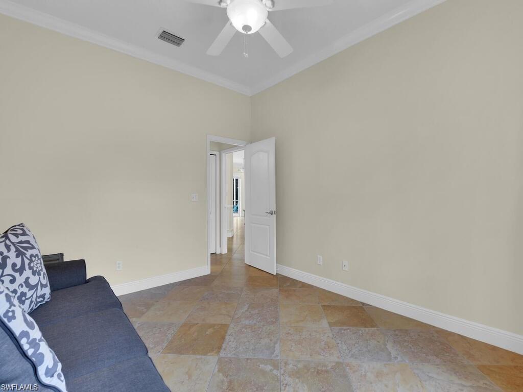 9983 Colonial Walk North Estero, FL 33928 - Photo 18 of 39 an empty room with a ceiling fan