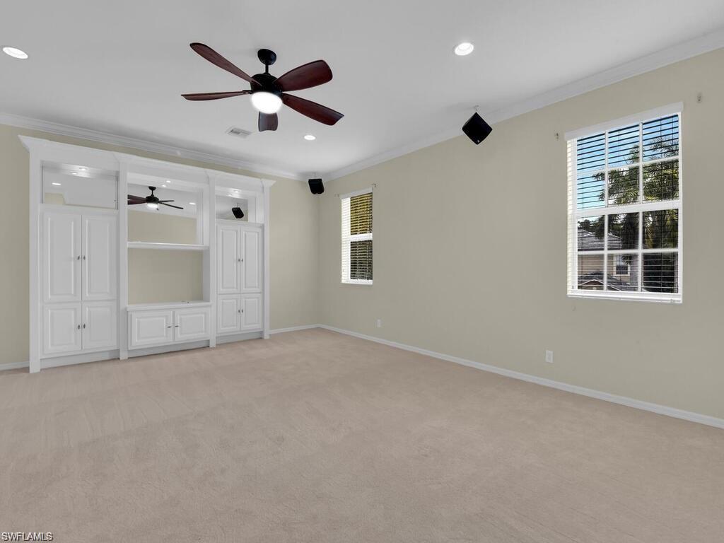 9983 Colonial Walk North Estero, FL 33928 - Photo 27 of 39 an empty room with ceiling fan and windows