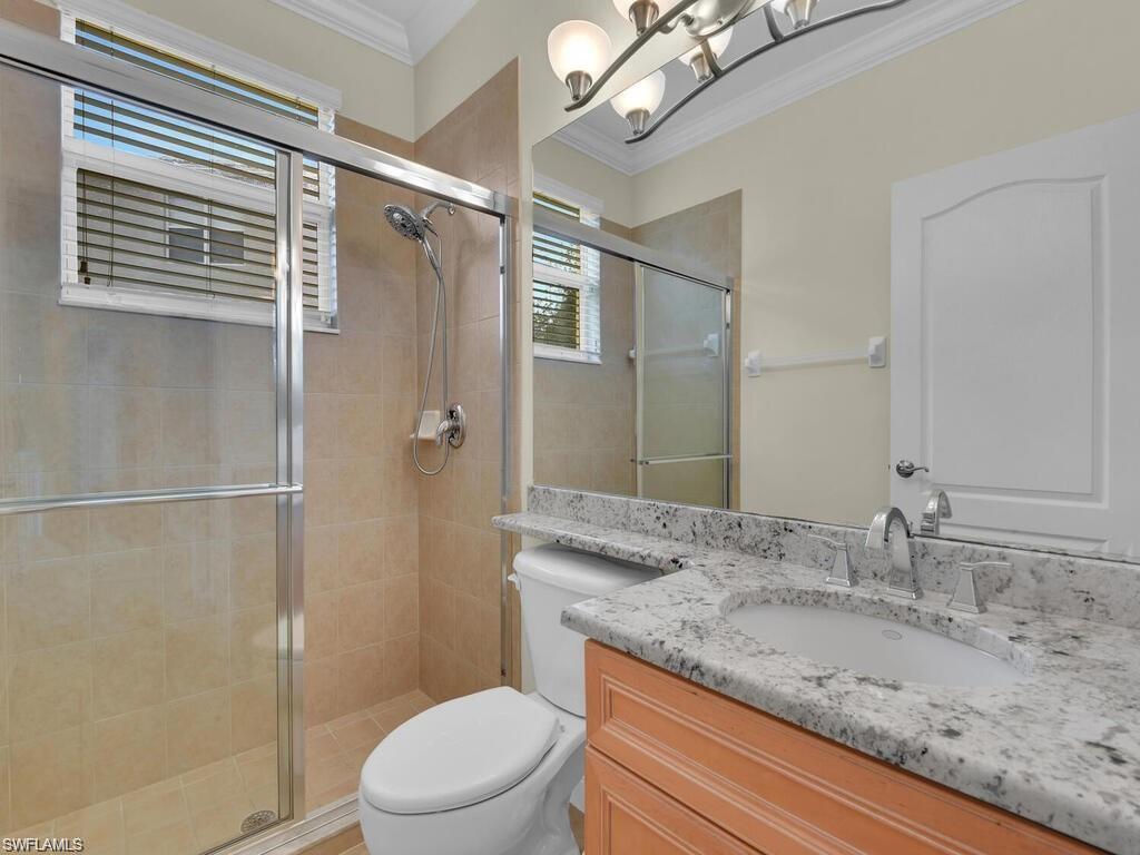 9983 Colonial Walk North Estero, FL 33928 - Photo 29 of 39 a bathroom with a granite countertop sink toilet and shower