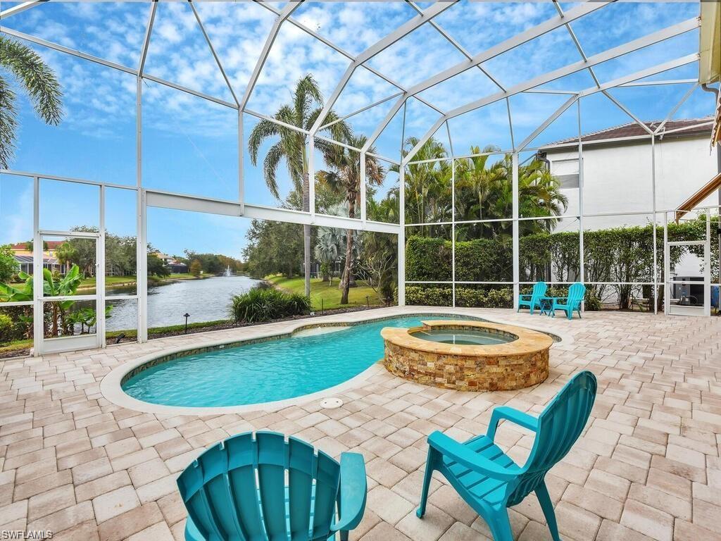 9983 Colonial Walk North Estero, FL 33928 - Photo 3 of 39 a view of a swimming pool with a patio