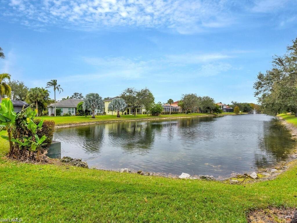 9983 Colonial Walk North Estero, FL 33928 - Photo 36 of 39 a view of a lake with houses in the back