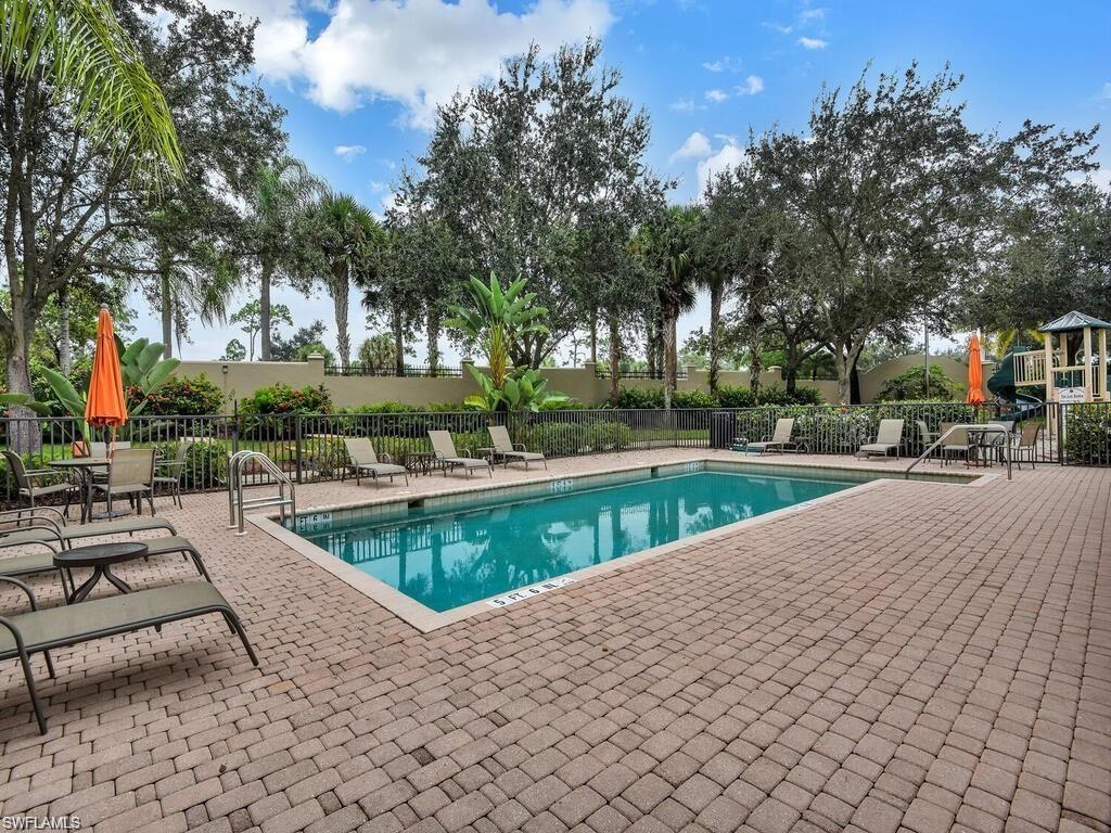 9983 Colonial Walk North Estero, FL 33928 - Photo 39 of 39 a view of swimming pool with outdoor seating and trees