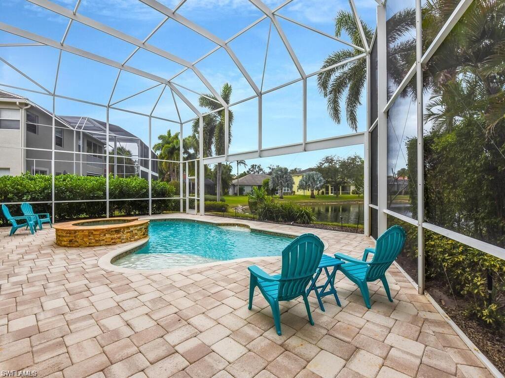 9983 Colonial Walk North Estero, FL 33928 - Photo 5 of 39 a view of swimming pool with lawn chairs and a yard