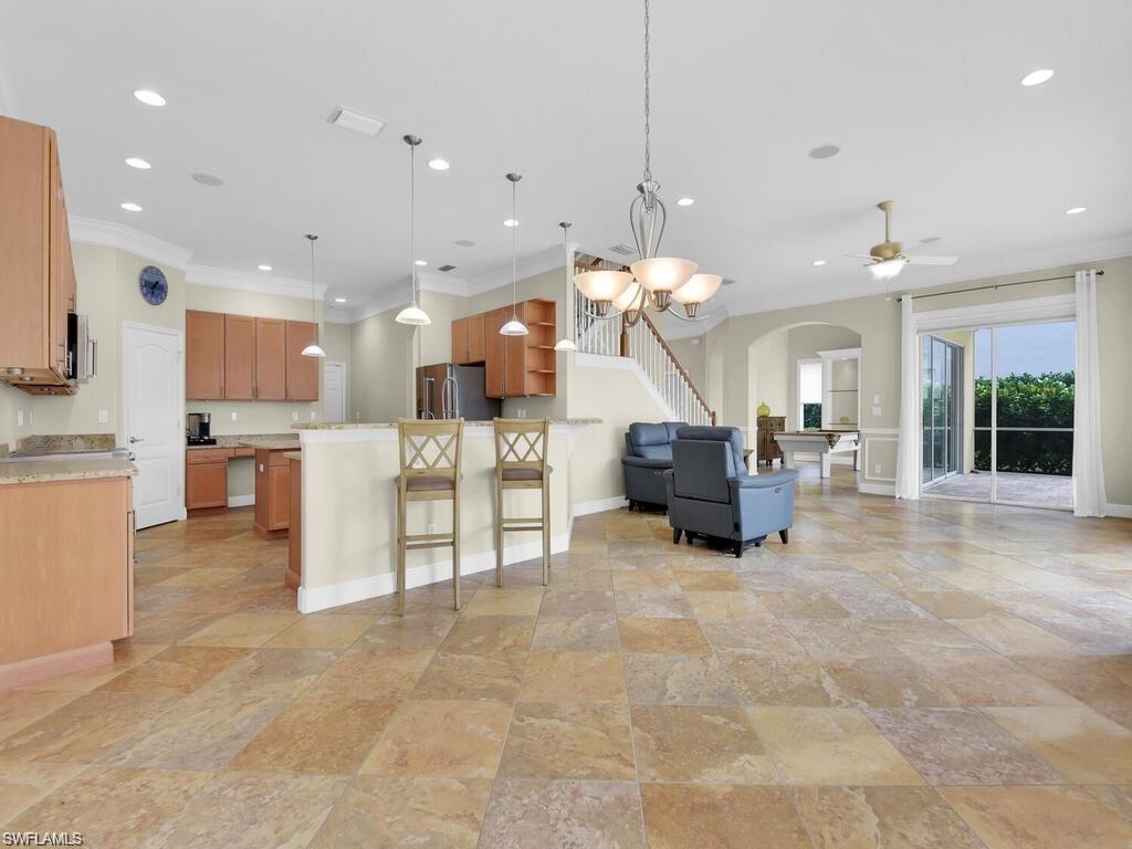 9983 Colonial Walk North Estero, FL 33928 - Photo 8 of 39 a large kitchen with a large counter top space a sink stainless steel appliances and cabinets