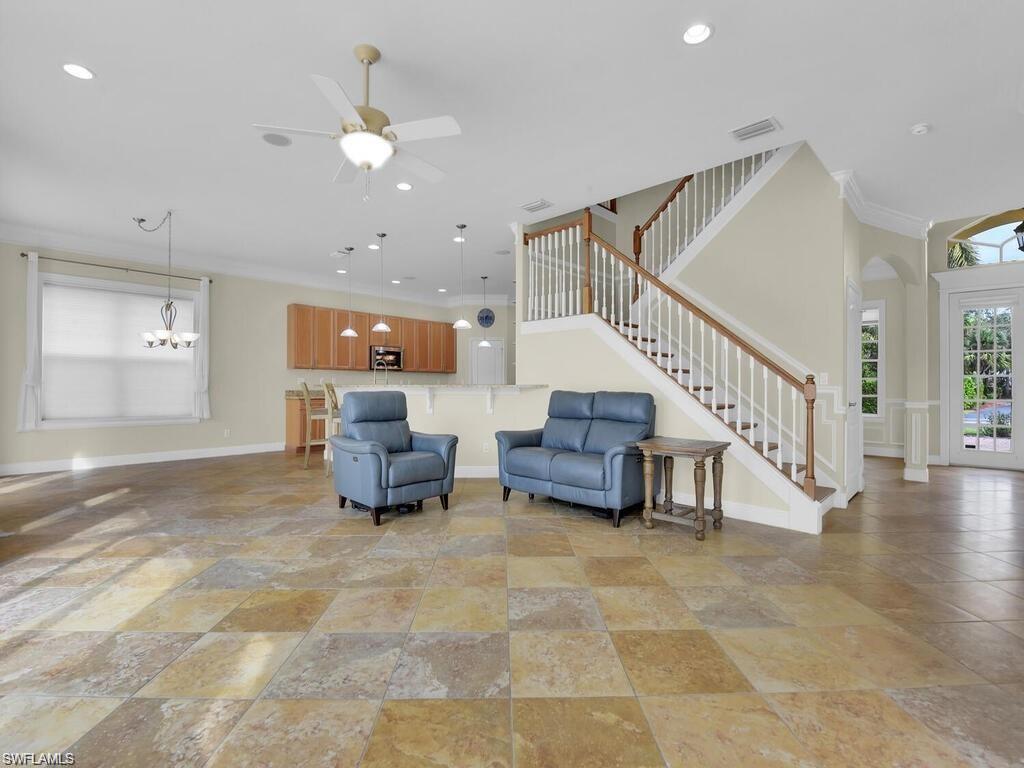 9983 Colonial Walk North Estero, FL 33928 - Photo 10 of 39 a living room with furniture and a chandelier